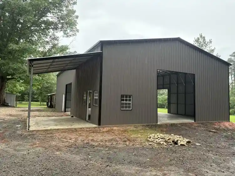 Large gray metal garage with multiple roll-up doors